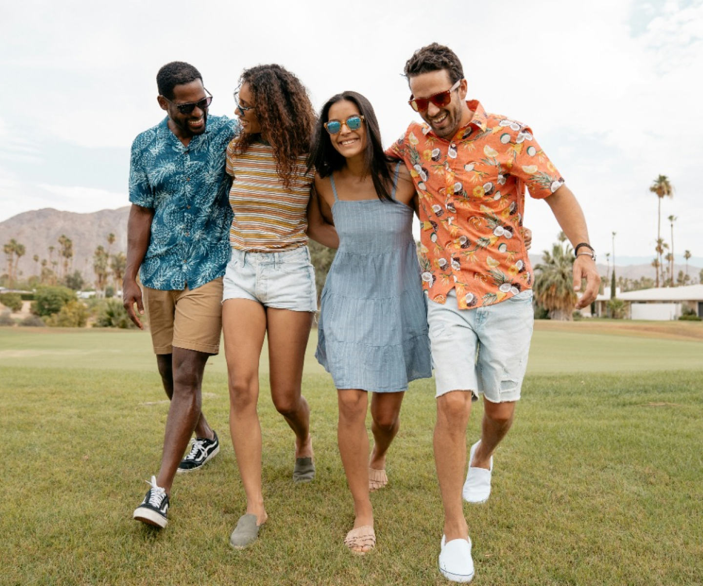 Four happy people walking